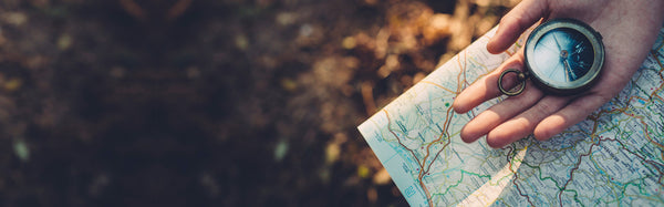 woman holding map and compass