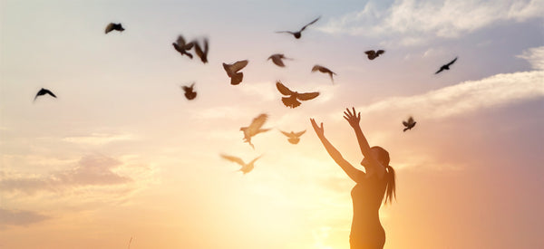 woman worships with doves